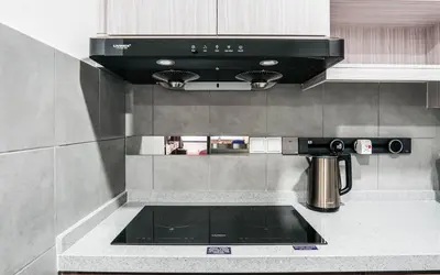 a kitchen with a black stove top oven at M Vertica KL by Airhost in Kuala Lumpur