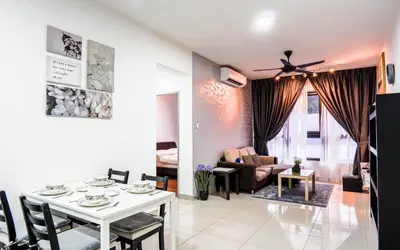 a living room with a white table and a couch at M Vertica KL by Airhost in Kuala Lumpur