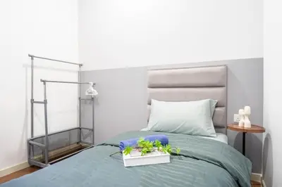 a bedroom with a bed with a blue comforter at M Vertica KL by Airhost in Kuala Lumpur
