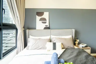 a bedroom with a bed with a stuffed animal on it at M Vertica KL by Airhost in Kuala Lumpur
