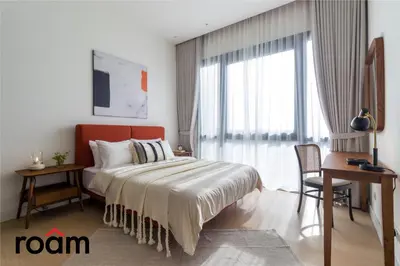 a bedroom with a bed and a desk and a window at ViiA Residences Kuala Lumpur in Kuala Lumpur