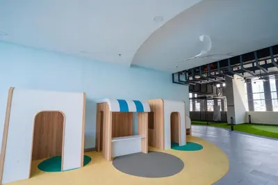 a room with tables and chairs in a building at Societe Suites By iHost Global in Kuala Lumpur