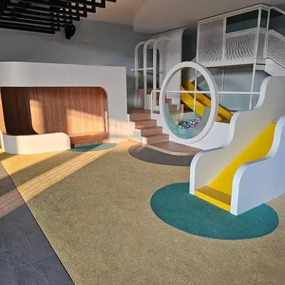 a childrens play room with a slide and a playground at Societe Suites By iHost Global in Kuala Lumpur