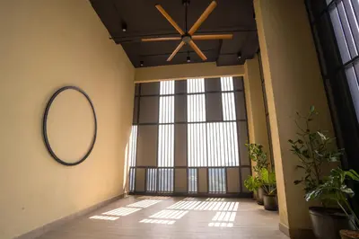 a hallway with a large window and a mirror on the wall at Societe Suites By iHost Global in Kuala Lumpur