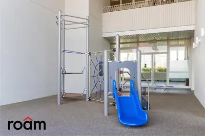 a gym with a blue slide in a room at UNA Residences, Sunway KL in Kuala Lumpur