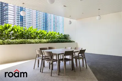 a table and chairs in a room with buildings at UNA Residences, Sunway KL in Kuala Lumpur