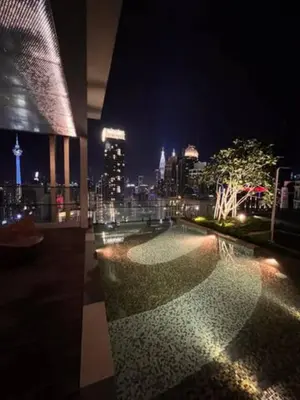 a building with a view of a city at night at Maxhome at Axon Bukit Bintang in Kuala Lumpur