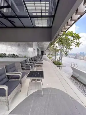 a row of chairs and tables on a building at Maxhome at Axon Bukit Bintang in Kuala Lumpur