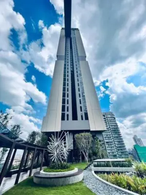 a tall building with a clock on the side of it at Maxhome at Axon Bukit Bintang in Kuala Lumpur