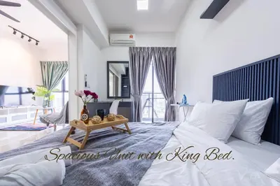 a bedroom with a king bed with a table at Continew 1BR High TRX Mall King Bed 100Mbps Wi-Fi in Kuala Lumpur