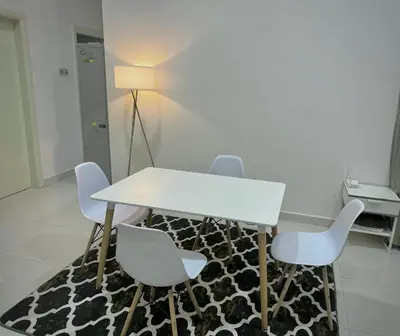 a white table and chairs in a room at HaBiBi hOmE Klcc in Kuala Lumpur