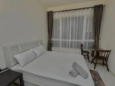 a bedroom with a bed with two towels on it at HaBiBi hOmE Klcc in Kuala Lumpur