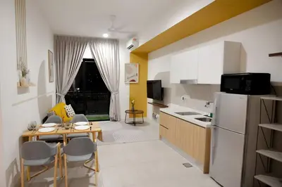 a small kitchen with a table and a refrigerator at The Gallery @ Pano Jln Ipoh -MRT. S/Check-In. Free Parking in Kuala Lumpur