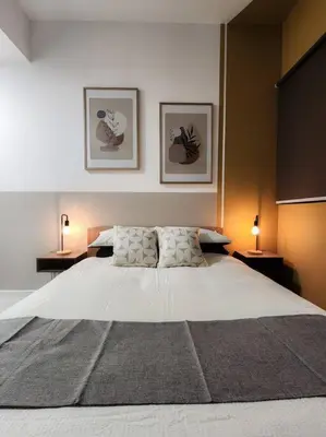 a large white bed in a bedroom with two lamps at The Gallery @ Pano Jln Ipoh -MRT. S/Check-In. Free Parking in Kuala Lumpur