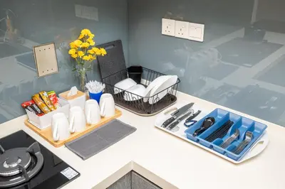 a kitchen counter with a tray of food and flowers at Bintang Fairlane Residences near Pavilion by GL Staycation in Kuala Lumpur