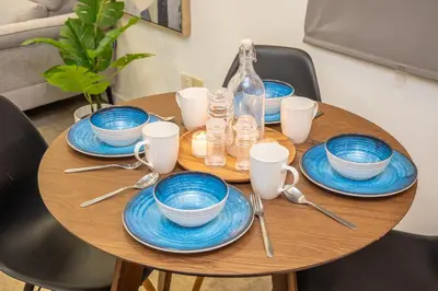a wooden table with blue and white dishes on it at Bintang Fairlane Residences near Pavilion by GL Staycation in Kuala Lumpur