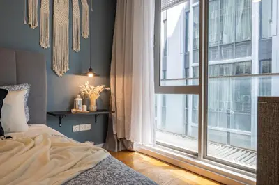a bedroom with a bed and a large window at Bintang Fairlane Residences near Pavilion by GL Staycation in Kuala Lumpur