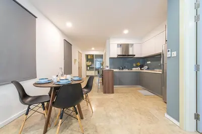 a kitchen and dining room with a table and chairs at Bintang Fairlane Residences near Pavilion by GL Staycation in Kuala Lumpur