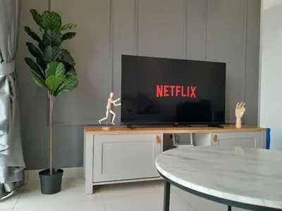 a tv sitting on top of a tv stand in a living room at 2Room 6pax 2 min to # Chan Sow Lin # TRX #Velocity #KLCC in Kuala Lumpur