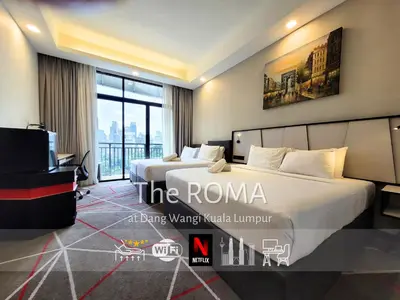 a hotel room with a bed and a tv at The Roma at Dang Wangi Kuala Lumpur in Kuala Lumpur