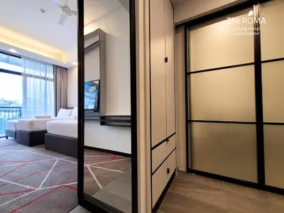 a room with a bed and a sliding glass door at The Roma at Dang Wangi Kuala Lumpur in Kuala Lumpur