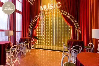 a room with red curtains and chairs and a stage at Scarletz Suites KLCC, Travelet in Kuala Lumpur
