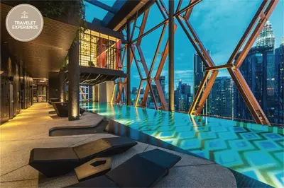 a swimming pool in the middle of a building with a city at Scarletz Suites KLCC, Travelet in Kuala Lumpur