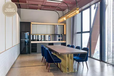 a dining room with a table and chairs and a refrigerator at Scarletz Suites KLCC, Travelet in Kuala Lumpur