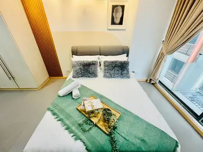 a bedroom with a bed with a tray of food on it at #125 Bintang Fairlane KLCC - Lot 10 - Pavilion - Fahrenheit for 1-5px in Kuala Lumpur