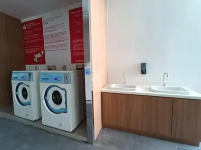 a bathroom with a washing machine and a sink at RM2a18 Bukit Bintang Balcony Studio in Kuala Lumpur