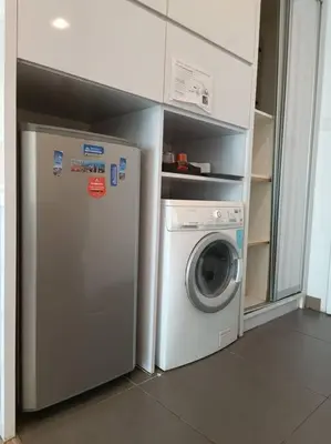 a kitchen with a washing machine and a washer at RM2a18 Bukit Bintang Balcony Studio in Kuala Lumpur