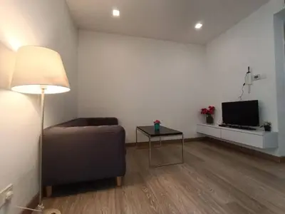 a living room with a couch and a table and a television at RM201 Bukit Bintang 2 Bedroom Balcony CIty View in Kuala Lumpur