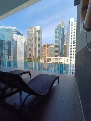 a bench on a balcony with a view of a city at RM203 Bukit Bintang Balcony Studio Infinity Pool in Kuala Lumpur