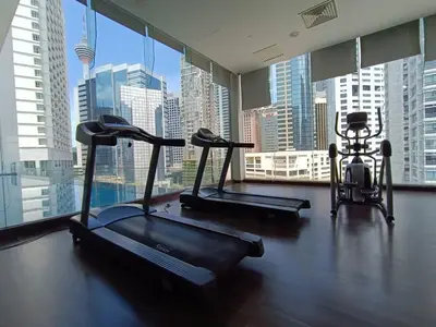 a gym with three exercise bikes and a large window at RM203 Bukit Bintang Balcony Studio Infinity Pool in Kuala Lumpur