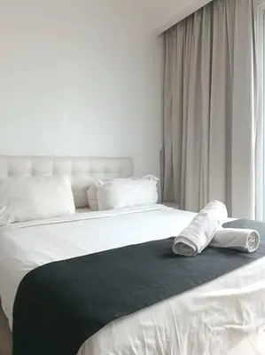 a bedroom with a bed with towels on it at RM203 Bukit Bintang Balcony Studio Infinity Pool in Kuala Lumpur