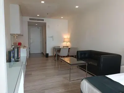 a living room with a couch and a table in a room at RM238 Bukit Bintang Balcony Studio Infinty Pool in Kuala Lumpur