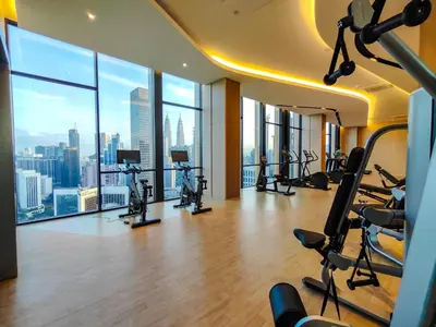 a gym with exercise equipment and a view of the city at The Axon Residence - Bukit Bintang Kuala Lumpur in Kuala Lumpur