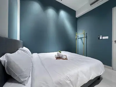 a woman laying on a bed in a room at KL Trion Residence near Velocity - IKEA - Lalaport - Bukit Bintang in Kuala Lumpur
