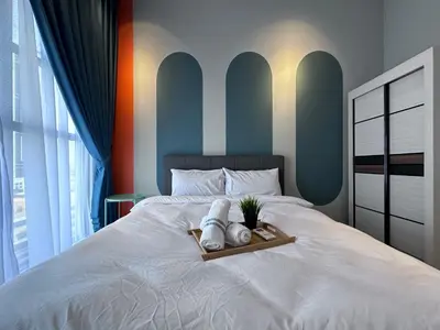 a bed with a tray with towels and a plant on it at KL Trion Residence near Velocity - IKEA - Lalaport - Bukit Bintang in Kuala Lumpur