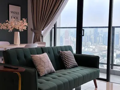 a green couch in a room with a large window at KL Trion Residence near Velocity - IKEA - Lalaport - Bukit Bintang in Kuala Lumpur