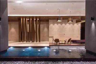 a lobby with a swimming pool in a building at Klcc studio with a rooftop garden playground in Kuala Lumpur