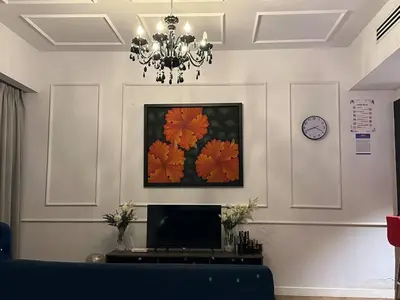 a living room with a chandelier and a tv at Klcc studio with a rooftop garden playground in Kuala Lumpur