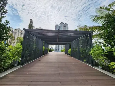 a bridge over a walkway in a city with buildings at The Play Suite@Pano. MRT. Free Parking. Self C/In in Kuala Lumpur