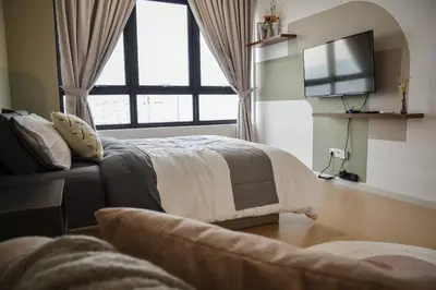 a bedroom with a bed and a tv and a couch at The Play Suite@Pano. MRT. Free Parking. Self C/In in Kuala Lumpur