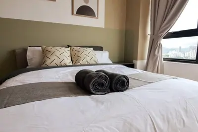 two towels sitting on top of a bed with a window at The Play Suite@Pano. MRT. Free Parking. Self C/In in Kuala Lumpur