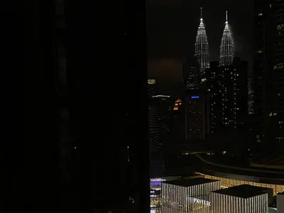 a view of a city skyline at night at KAĨTE Homestay at Fahrenheit88 Bukit Bintang, Opposite Pavilion KL in Kuala Lumpur