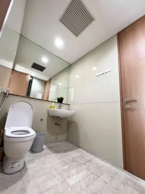 a bathroom with a toilet and a sink at Soho Suites, Centrally Located at KL City Centre in Kuala Lumpur