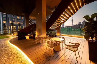 a deck with tables and chairs on a building at Axon Residence Bukit Bintang Kuala Lumpur By Apex in Kuala Lumpur