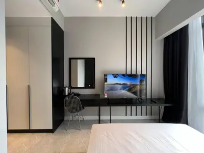 a bedroom with a bed and a desk with a television at Axon Residence Bukit Bintang Kuala Lumpur By Apex in Kuala Lumpur