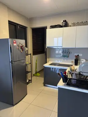 a kitchen with a stainless steel refrigerator and cabinets at Queen Room At KL Gateway Residence LRT Linked in Kuala Lumpur